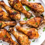 Juicy grilled chicken drumsticks on a summer BBQ grill